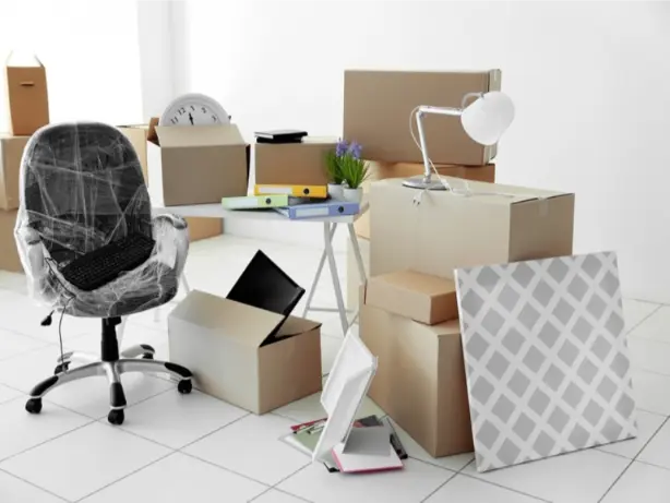 bunch of office furniture and boxes about to be packed because of a business move